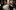 BAC_Commercial_Photography_Full_Res-211 A woman with fair hair tied back, dressed all in black, pours champagne into rows of glasses on top of a bar