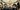 BAC_Commercial_Photography_Full_Res-216 A party of people in the octagonal hall, a room with arches supported by marble pillars, a classical style statue in the left hand corner, and a stained glass domed ceiling. There is a table of filled champagne flutes on the right