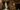 Weddings_masthead_image An image of a married couple stood within the doorway from the Grand Hall East Corridor into the Grand Hall. They hold hands, the groom on the left wearing a grey suit and pink bow tie, and the bride wearing a long white wedding dress, her train delicately flowing to her side.