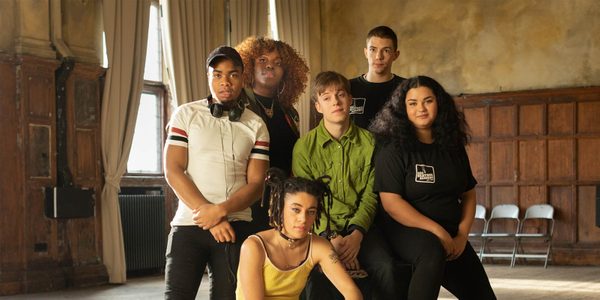 An image of the BAC Beatbox Academy. A group of six young people in Battersea Arts Centre's Council Chamber: an old town hall building with wooden panels on the walls.