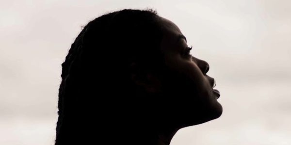 Fabulation MH A Global Majority Woman in profile and partial silhouette looks up at the sky
