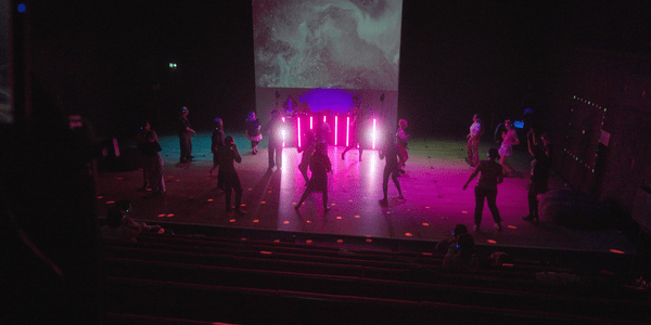 A group of people dancing on the Disco Neurotico dance floor. They are all wearing headphones.